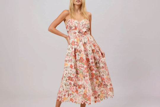 Woman wearing floral lace midi dress for a wedding - Style guide by Self Indulge