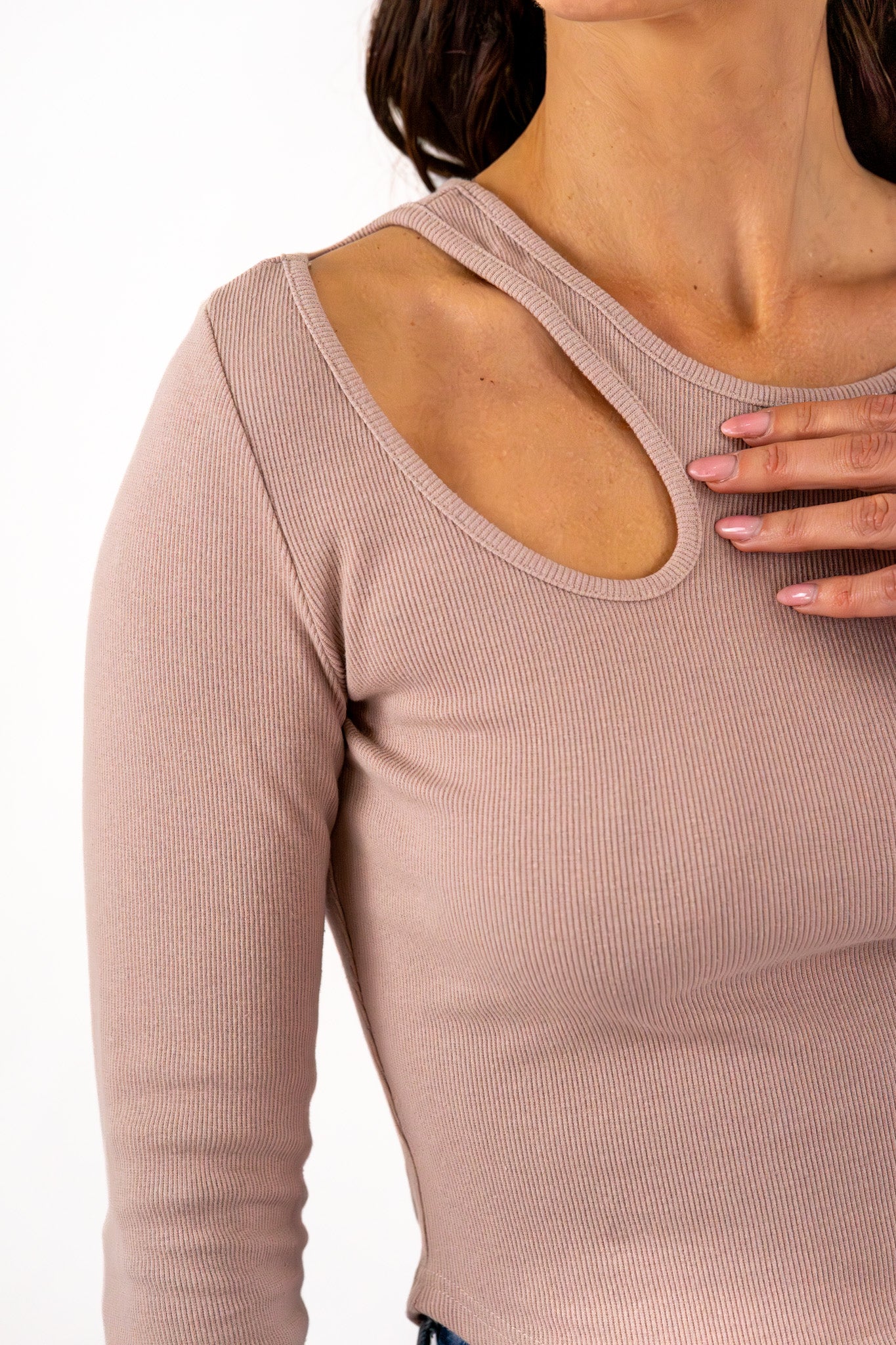 Close-up of a taupe ribbed top showcasing a fashionable shoulder cutout design, emphasizing the textured fabric.