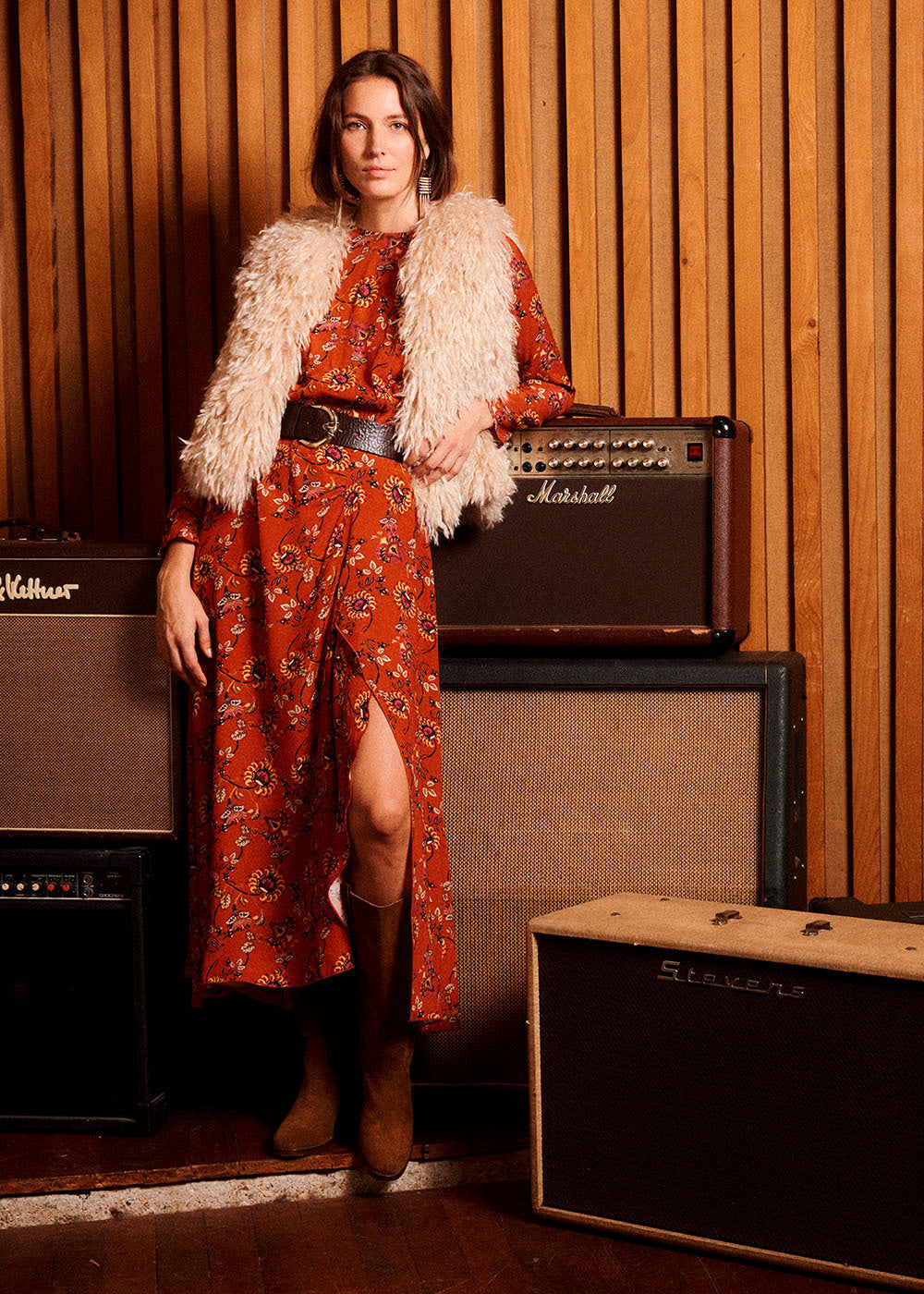 Zoani Faux Shearling Sleeveless Jacket styled with a red floral maxi dress, leather belt, and boots.