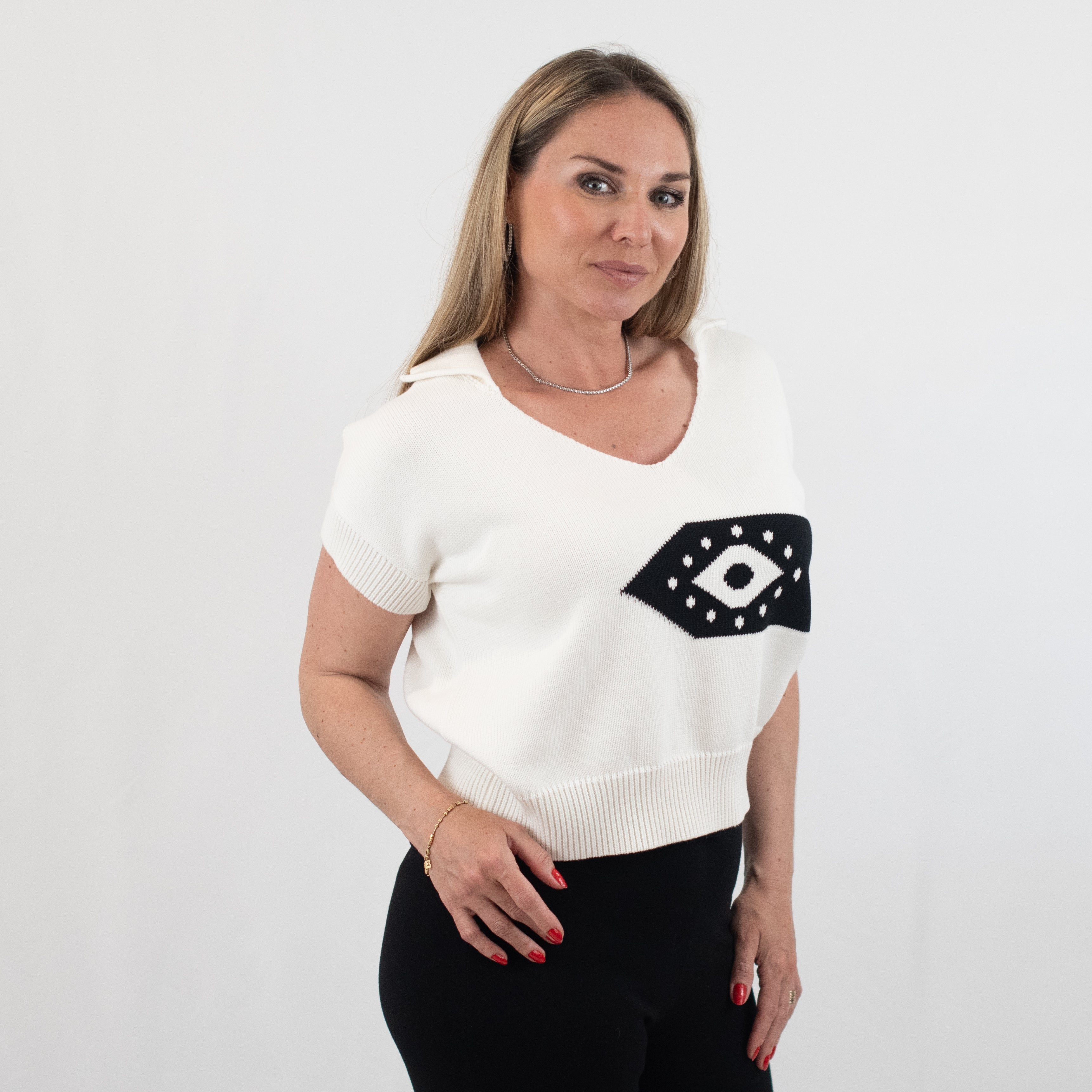 Model in a white Ada short sleeve V-neck jumper with black eye design, highlighting side angle and the comfortable, stylish fit perfect for casual or semi-formal wear.