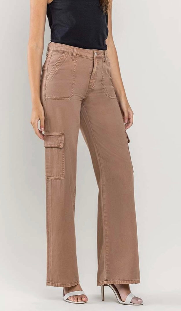 Side angle of brown wide-leg cargo pants featuring utility details, paired with a black tank top and white heels.