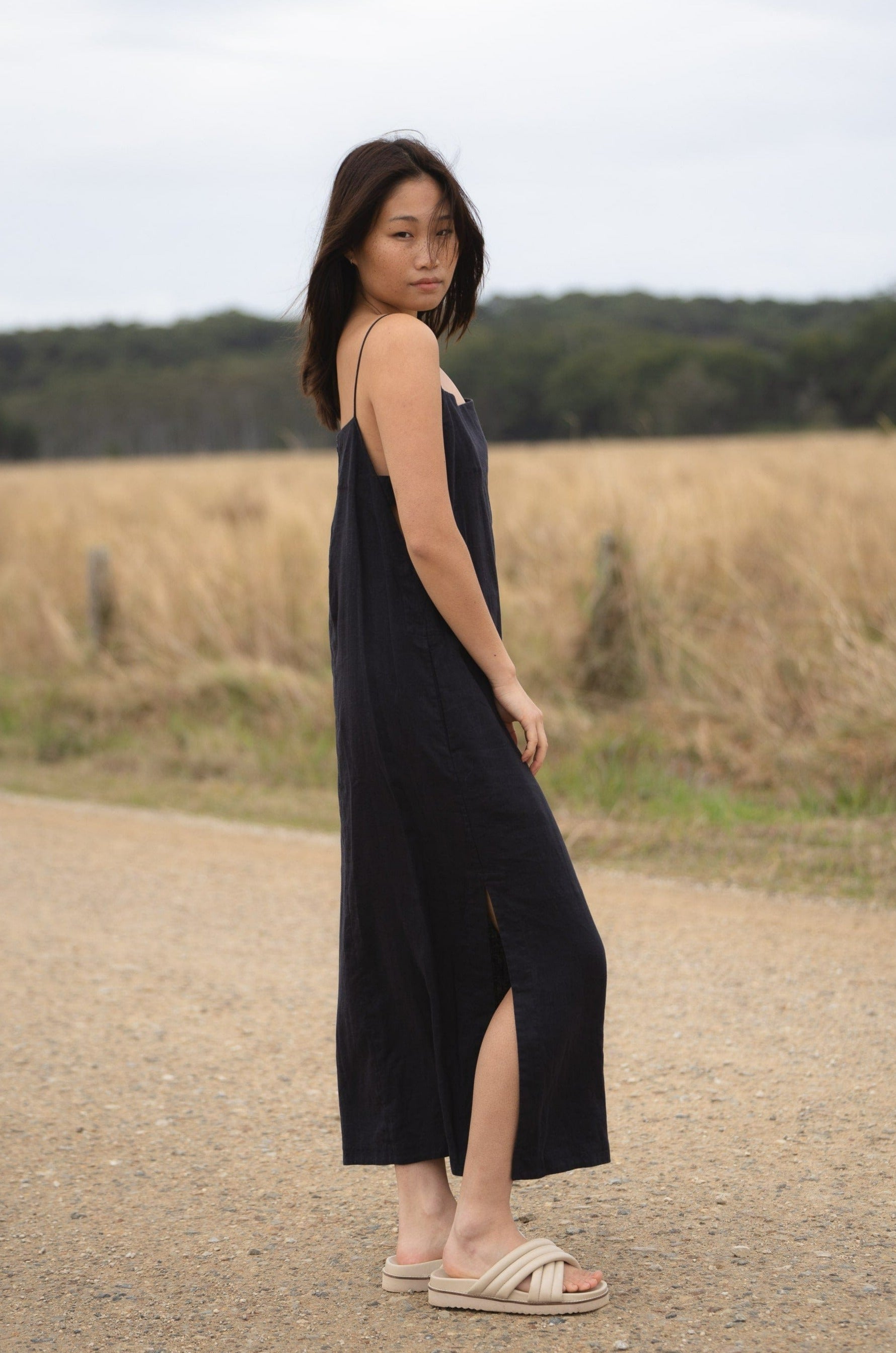 Front view of a Kai linen navy midi dress showcasing a scoop neckline and relaxed fit, perfect for a sophisticated summer look.